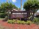 Breezewood Village Condominiums community sign amidst lush greenery and landscaping at 101 Grand Plaza Dr # A30, Orange City, FL 32763