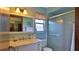 Bathroom with a large mirror over a marble vanity and sink, toilet and glass shower enclosure at 104 Nathan Hale Ct, Daytona Beach, FL 32119