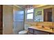Bathroom featuring a shower, toilet, vanity with a peach-colored sink, mirror and window at 104 Nathan Hale Ct, Daytona Beach, FL 32119