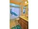 Bathroom with a toilet, a tub with a shower curtain, and wooden vanity with a white sink at 104 Nathan Hale Ct, Daytona Beach, FL 32119