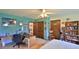 Bedroom features blue walls, a desk, a chair, a closet and a bookcase at 104 Nathan Hale Ct, Daytona Beach, FL 32119