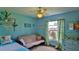 Bedroom featuring blue walls, a ceiling fan, two beds, window, dresser and shelving at 104 Nathan Hale Ct, Daytona Beach, FL 32119