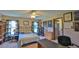 Bedroom features a bed, ceiling fan, two windows, a desk and two bookcases at 104 Nathan Hale Ct, Daytona Beach, FL 32119