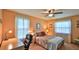 Bright bedroom with large windows, a ceiling fan, and a cozy bed at 104 Nathan Hale Ct, Daytona Beach, FL 32119