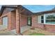 Close up of a brick home's covered front entrance showing a bay window and attached garage at 104 Nathan Hale Ct, Daytona Beach, FL 32119