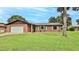 Charming brick home featuring an attached garage and a lush green lawn at 104 Nathan Hale Ct, Daytona Beach, FL 32119