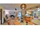 Cozy living and dining area with a brick fireplace and hardwood dining set at 104 Nathan Hale Ct, Daytona Beach, FL 32119