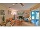 Inviting living room showcasing a cozy fireplace and access to the screened patio at 104 Nathan Hale Ct, Daytona Beach, FL 32119