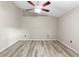 Bedroom featuring wood-look floors, neutral paint, and a ceiling fan at 105 Golfside Cir, Sanford, FL 32773