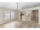 Inviting dining area with natural light, wood floors, and chandelier at 105 Golfside Cir, Sanford, FL 32773