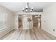 Dining room with modern chandelier, adjacent to kitchen and features wood-look flooring at 105 Golfside Cir, Sanford, FL 32773