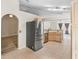 Bright kitchen features stainless steel refrigerator, tile floors and a view of the adjacent living room at 105 Golfside Cir, Sanford, FL 32773