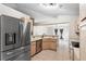 Updated kitchen with stainless steel appliances and a view into an adjacent dining area with modern flooring at 105 Golfside Cir, Sanford, FL 32773