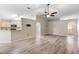 Bright and airy living area showcasing wood floor, open layout, and a breakfast bar overlooking the kitchen at 105 Golfside Cir, Sanford, FL 32773
