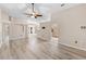 Open concept living space featuring wood floor, neutral walls, and views of the kitchen and dining area at 105 Golfside Cir, Sanford, FL 32773