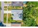 An aerial view of a single Gathering home with a gray roof, landscaping, and tree coverage at 105 Riviera Estates Blvd, Ormond Beach, FL 32174