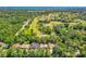 Aerial shot showcases the property's proximity to the Riviera Country Club and lush green surroundings at 105 Riviera Estates Blvd, Ormond Beach, FL 32174