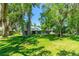 Beautiful backyard with mature trees and lush green lawn, offering a peaceful and private outdoor space at 105 Riviera Estates Blvd, Ormond Beach, FL 32174