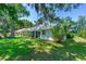 Lush backyard with well-maintained lawn and views of mature trees, ideal for relaxation and recreation at 105 Riviera Estates Blvd, Ormond Beach, FL 32174