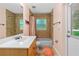 Bathroom with tiled shower, tub and a view to the outside at 105 Riviera Estates Blvd, Ormond Beach, FL 32174