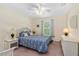 Cozy bedroom with white wicker furniture, a ceiling fan, and a window view at 105 Riviera Estates Blvd, Ormond Beach, FL 32174
