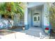 Inviting front porch with tiled flooring, potted plants, and decorative columns enhancing the home's curb appeal at 105 Riviera Estates Blvd, Ormond Beach, FL 32174