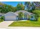 Charming single-story home with a manicured lawn, complemented by a well-maintained garden and a two-car garage at 105 Riviera Estates Blvd, Ormond Beach, FL 32174