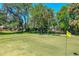Scenic view of the golf course with lush green fairway and mature trees, offering recreational opportunities at 105 Riviera Estates Blvd, Ormond Beach, FL 32174
