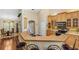 Cozy kitchen featuring wooden cabinets, black appliances, and breakfast bar area at 105 Riviera Estates Blvd, Ormond Beach, FL 32174