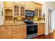 Modern kitchen with wooden cabinets, stainless steel appliances, and tiled backsplash at 105 Riviera Estates Blvd, Ormond Beach, FL 32174