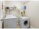 Efficient laundry room featuring a washer, dryer, and storage shelving for supplies and accessories at 105 Riviera Estates Blvd, Ormond Beach, FL 32174