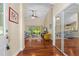 Open-concept living room with hardwood floors, a vaulted ceiling, and sliding glass doors leading to the backyard at 105 Riviera Estates Blvd, Ormond Beach, FL 32174