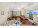 Bright living room with tray ceiling, fan, and natural light with curtains at 105 Riviera Estates Blvd, Ormond Beach, FL 32174