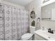 Well-lit bathroom features a decorative shower curtain, modern sink, and neutral decor at 1135 5Th St, Orange City, FL 32763