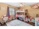 Charming bedroom features a bunk bed, colorful decor, and a window for natural light at 1135 5Th St, Orange City, FL 32763