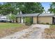 Charming single-story home with green roof, complemented by a well-maintained front yard at 1135 5Th St, Orange City, FL 32763
