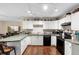 Well-lit kitchen with white cabinetry and modern appliances offers an open design at 1135 5Th St, Orange City, FL 32763