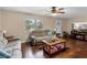 Cozy living room with hardwood floors, comfortable seating, ceiling fan, and a fireplace at 1135 5Th St, Orange City, FL 32763
