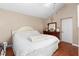 Cozy bedroom with a white bed, complemented by a mirrored vanity and neutral wall color at 1135 5Th St, Orange City, FL 32763
