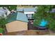 Aerial view of an inviting above ground pool and shed in a fenced backyard, with mature trees at 1135 5Th St, Orange City, FL 32763