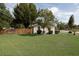 Well-maintained backyard with green lawn and mature trees, providing a private outdoor space at 1148 Briarwood Ave, Deltona, FL 32725
