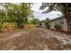 Large backyard with mature trees, fencing, and a covered outdoor sitting area at 1148 Briarwood Ave, Deltona, FL 32725
