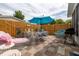 Outdoor living space featuring a brick patio, seating, and a blue umbrella at 1148 Briarwood Ave, Deltona, FL 32725