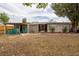 Spacious backyard featuring a covered area with green chairs for outdoor relaxing at 1148 Briarwood Ave, Deltona, FL 32725