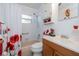 Bright bathroom with a shower and tub combo and a vanity with wood cabinets and decorative accents at 1148 Briarwood Ave, Deltona, FL 32725