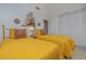 Bright bedroom featuring two twin beds, ornate gold accents, soft lighting, and spacious closet at 1148 Briarwood Ave, Deltona, FL 32725