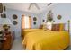 Bright bedroom with two twin beds, ornate gold accents, soft lighting, and decorative wall hangings at 1148 Briarwood Ave, Deltona, FL 32725