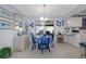 Charming dining area featuring a table with blue and white checkered tablecloth, adjacent to the kitchen at 1148 Briarwood Ave, Deltona, FL 32725