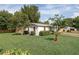 Charming single-story home with a well-maintained lawn and mature landscaping at 1148 Briarwood Ave, Deltona, FL 32725