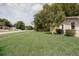 Well-manicured front lawn and the side of a single-story home with mature landscaping at 1148 Briarwood Ave, Deltona, FL 32725